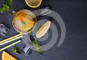 Lemonade in a glass jar on black background