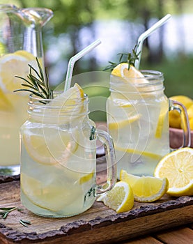 Lemonade in glass jars on table outdoors