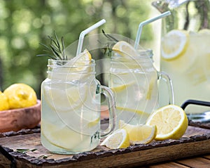 Lemonade in glass jars on table outdoors