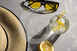 Lemonade with ice with hat and sunglasses. Summer holidays vacation concept background