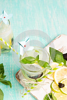 Lemonade or mojito cocktail with lemon, lime, and basil