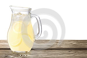 Lemonade pitcher on wooden table photo