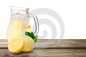 Lemonade pitcher on wooden table photo