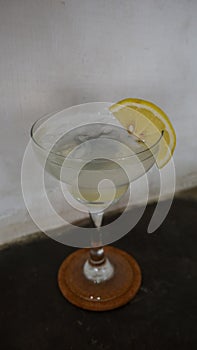 Lemonade. refreshing sparkling drink in an elegant glass garnished with a lemon wedge