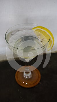 Lemonade. refreshing sparkling drink in an elegant glass garnished with a lemon wedge