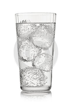 Lemonade sparkling mineral water with ice cubes and bubbles on white background