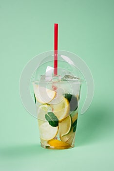 Lemonade to go cup on lightgreen background, isolated