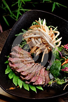 Lemongrass grilled beef steak with snow peas