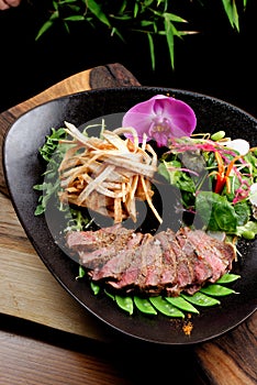 Lemongrass grilled beef steak with snow peas