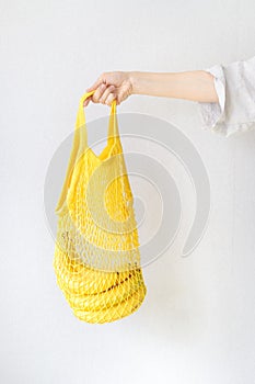 Lemons bananas and oranges in a string bag, shopping bag