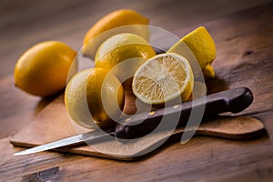 Lemons cut into the old kitchen board with mint leaves