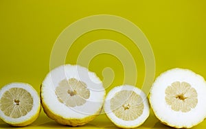 Lemons cut on yellow background