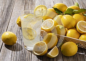 Lemons and lemon sours in a basket set against a wooden background