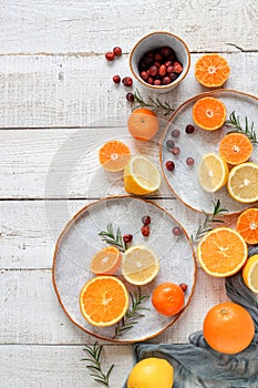 Lemons, mandarins and oranges on a white wooden table. Flat lay view