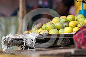 Lemons on a wooden tray at the food market in Nosy Be, Madagascar
