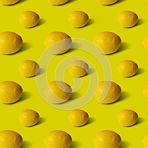 Lemons on yellow background, flat lay, top view, pattern.