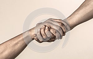 Lending a helping hand. Handshake, arms friendship. Friendly handshake, friends greeting, teamwork, friendship. Close-up