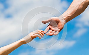 Lending a helping hand. Solidarity, compassion, and charity, rescue. Hands of man and woman reaching to each other