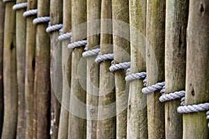 Length of wood fencing tied with rope