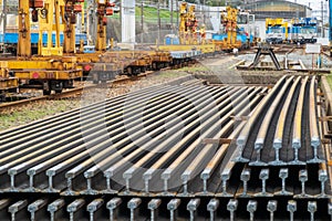 Lengths of rail stacked in train yard