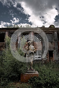 Lenin Monument on the background of an abandoned building in Novokuznetsk, Kemerovo region, Russia