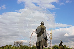 Lenin statue looking at Ferris wheel, Moscow