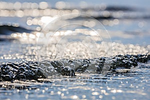 Lens blur foreground and background of wave bubble with bokeh from sun set light