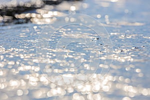 Lens blur foreground and background of wave bubble with bokeh from sun set light