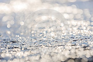 Lens blur foreground and background of wave bubble with bokeh from sun set light