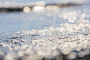 Lens blur foreground and background of wave bubble with bokeh from sun set light