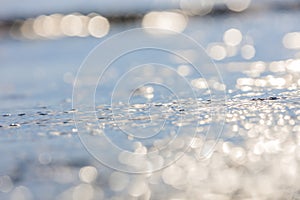 Lens blur foreground and background of wave bubble with bokeh from sun set light