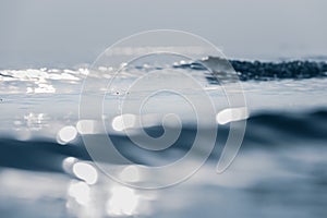 Lens blur foreground and background of wave bubble with bokeh from sun set light