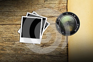 Lens camera with photo frame on wood background