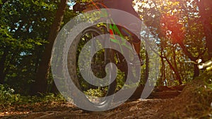 LENS FLARE: Cool shot of a man riding an electric bike through the sunlit woods.