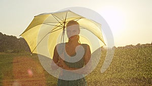 LENS FLARE: Gorgeous blonde woman smiles while looking into camera in the rain.