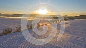 LENS FLARE: Subtle mist rising from the snowy fields on a sunny winter morning.