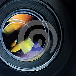 Lens and hood, large detailed macro zoom closeup, black, blue, green, red reflections in glass