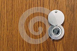 Lens peephole on new wooden texture front door