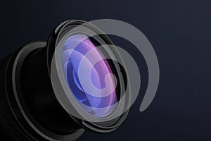 Lens of professional camera on  blue background, closeup. Space for text