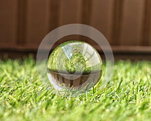 Lensball photo reflect grass on brown background