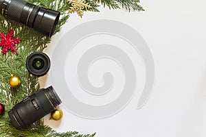 Lenses for reflex camera and Christmas decorations on a white background