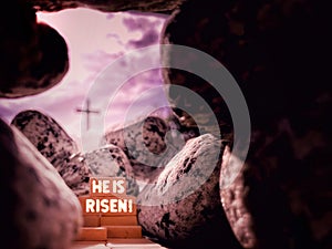 Lent, Holy Week, Easter Sunday Concept - HE IS RISEN text with Jesus Christ empty tomb, with blurry cross shape background.