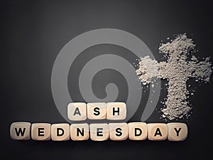 Lent Season, Holy Week, Ash Wednesday concepts. Ash Wednesday text on wooden cubes with ash cross symbol in dark background.