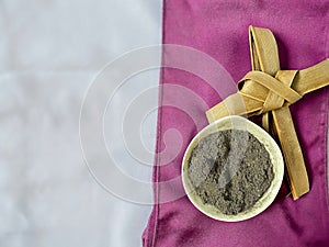 Lent Season,Holy Week and Good Friday Concepts - image of bowl of ash with cross made of palm leave background. Stock photo.