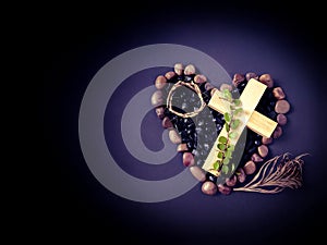 Lent Season,Holy Week and Good Friday concepts - image of cross, crown of thorns on stones and palm leave background. Stock photo.