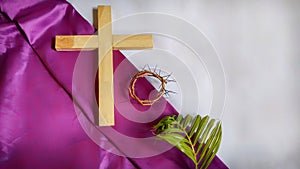 Lent Season,Holy Week and Good Friday concepts - image of wooden cross,crown of thorns and palm leave in vintage background