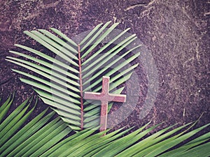 Lent Season,Holy Week and Good Friday concepts - image of wooden cross and heart shaped of palm leaf in purple vintage background.