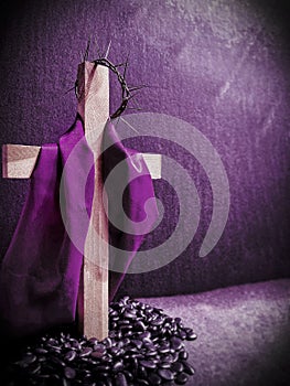 Lent Season,Holy Week and Good Friday concepts - image of wooden cross in purple vintage background. Stock photo.