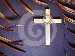 Lent Season,Holy Week and Good Friday concepts - photo of wooden cross, crown of thorns and palm leave in vintage background