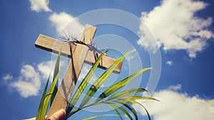 Lent season,Holy Week and Good Friday concepts - photo of wooden cross raise with sky background